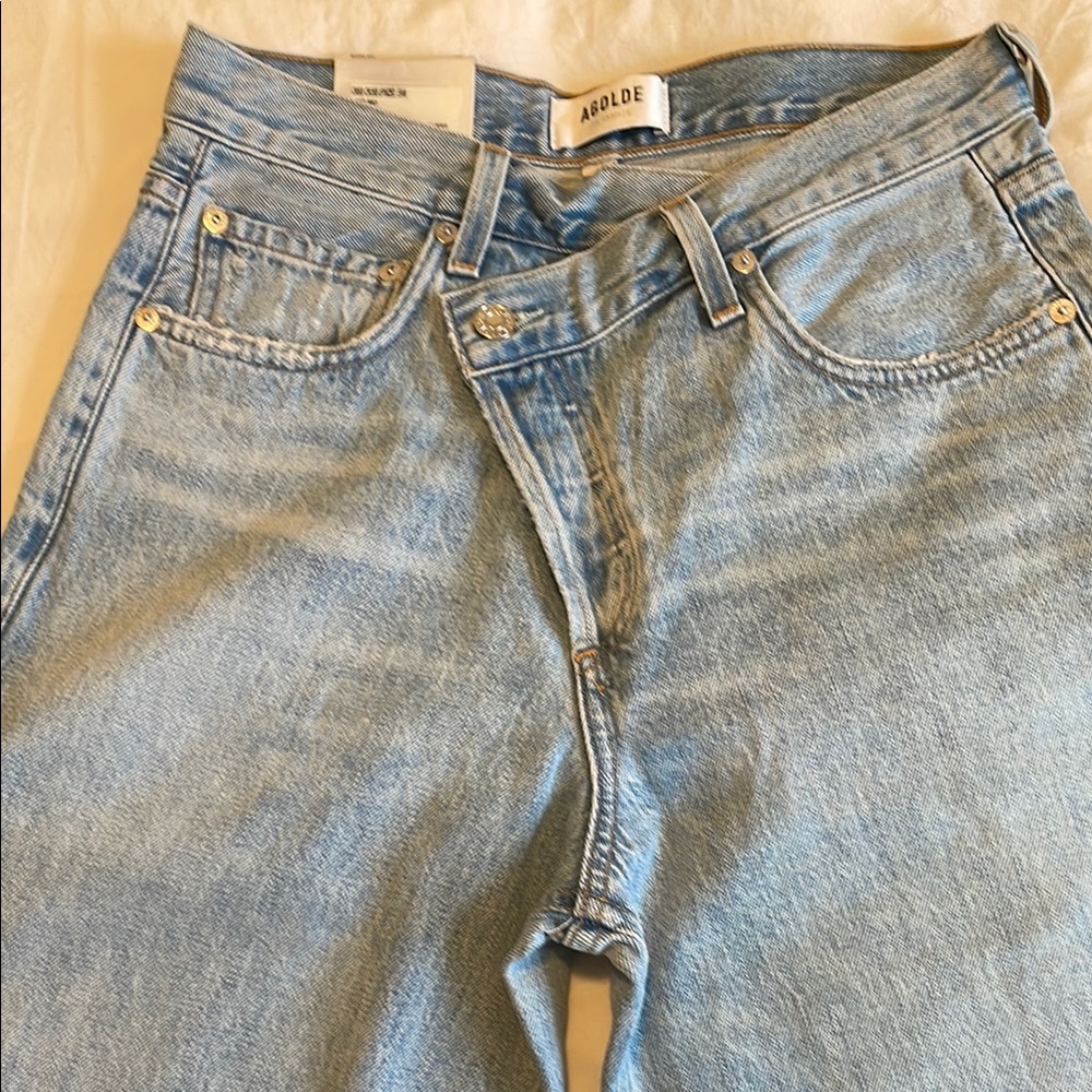 AGOLDE Crisscross upsize Light Wash Denim Jeans in suburbia.